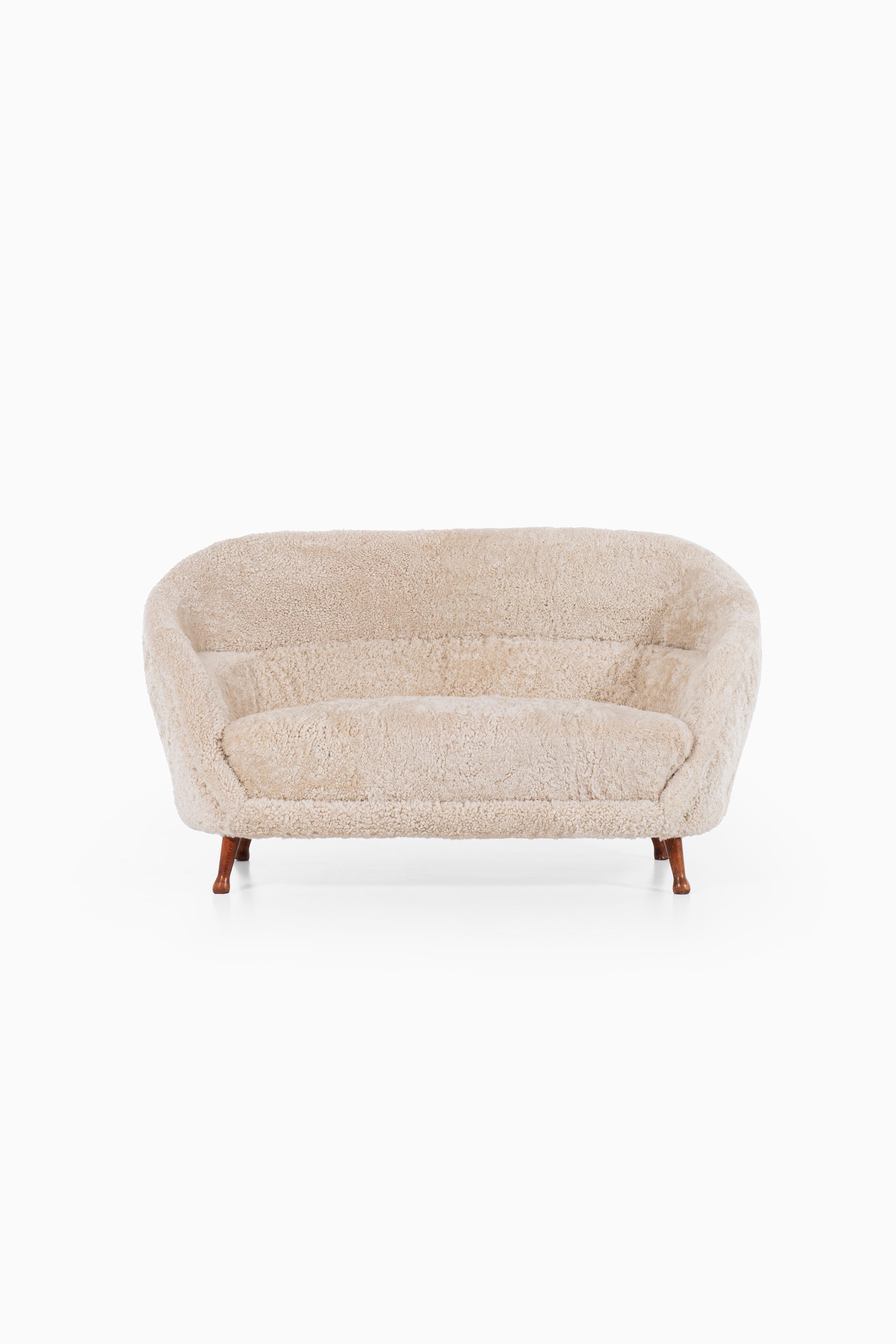 Arne Norell sofa in dark stained beech and sheepskin at Studio Schalling