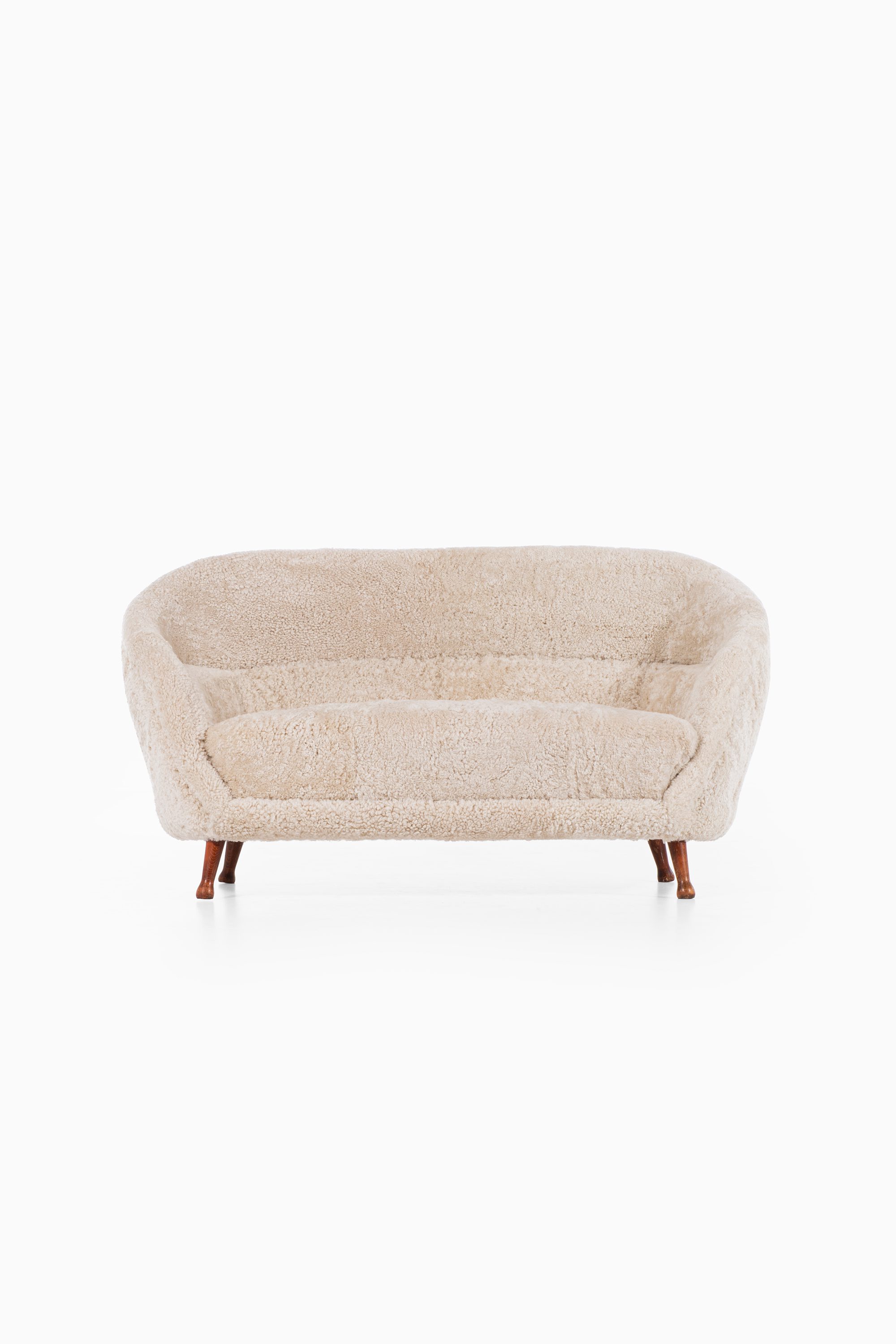 Arne Norell sofa in dark stained beech and sheepskin at Studio Schalling