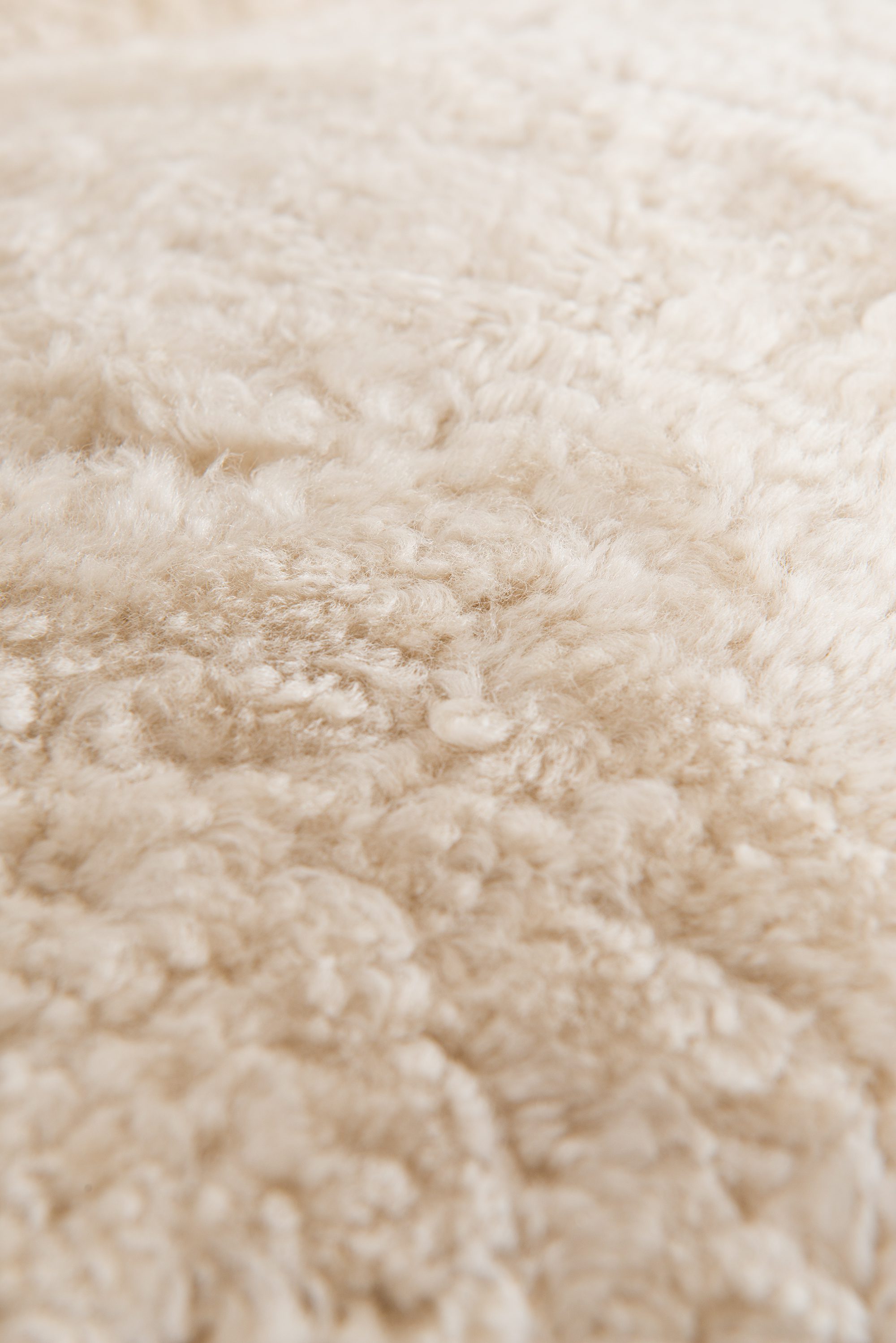 Arne Norell sofa in dark stained beech and sheepskin at Studio Schalling