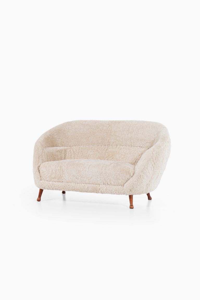 Arne Norell sofa in dark stained beech and sheepskin at Studio Schalling