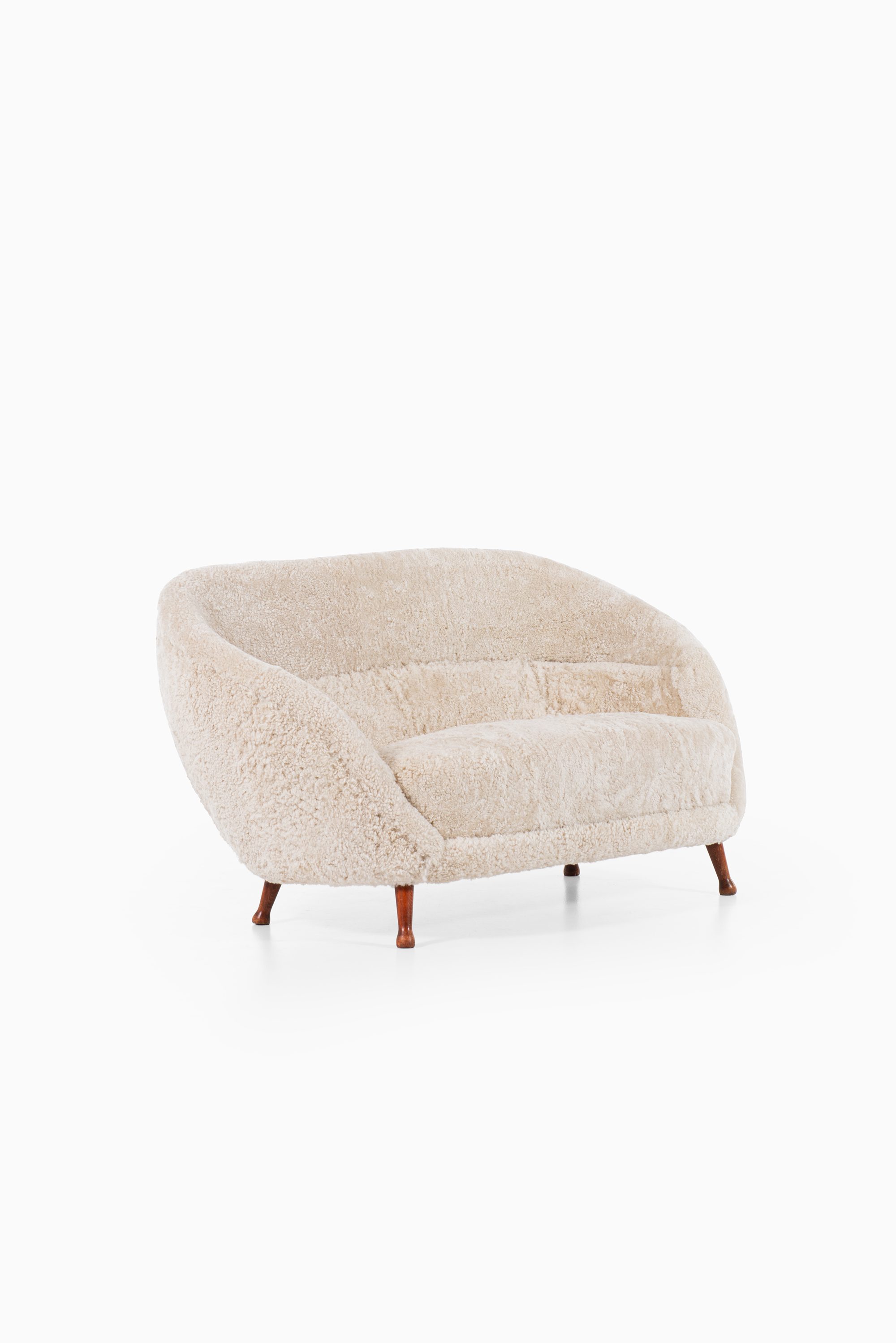 Arne Norell sofa in dark stained beech and sheepskin at Studio Schalling