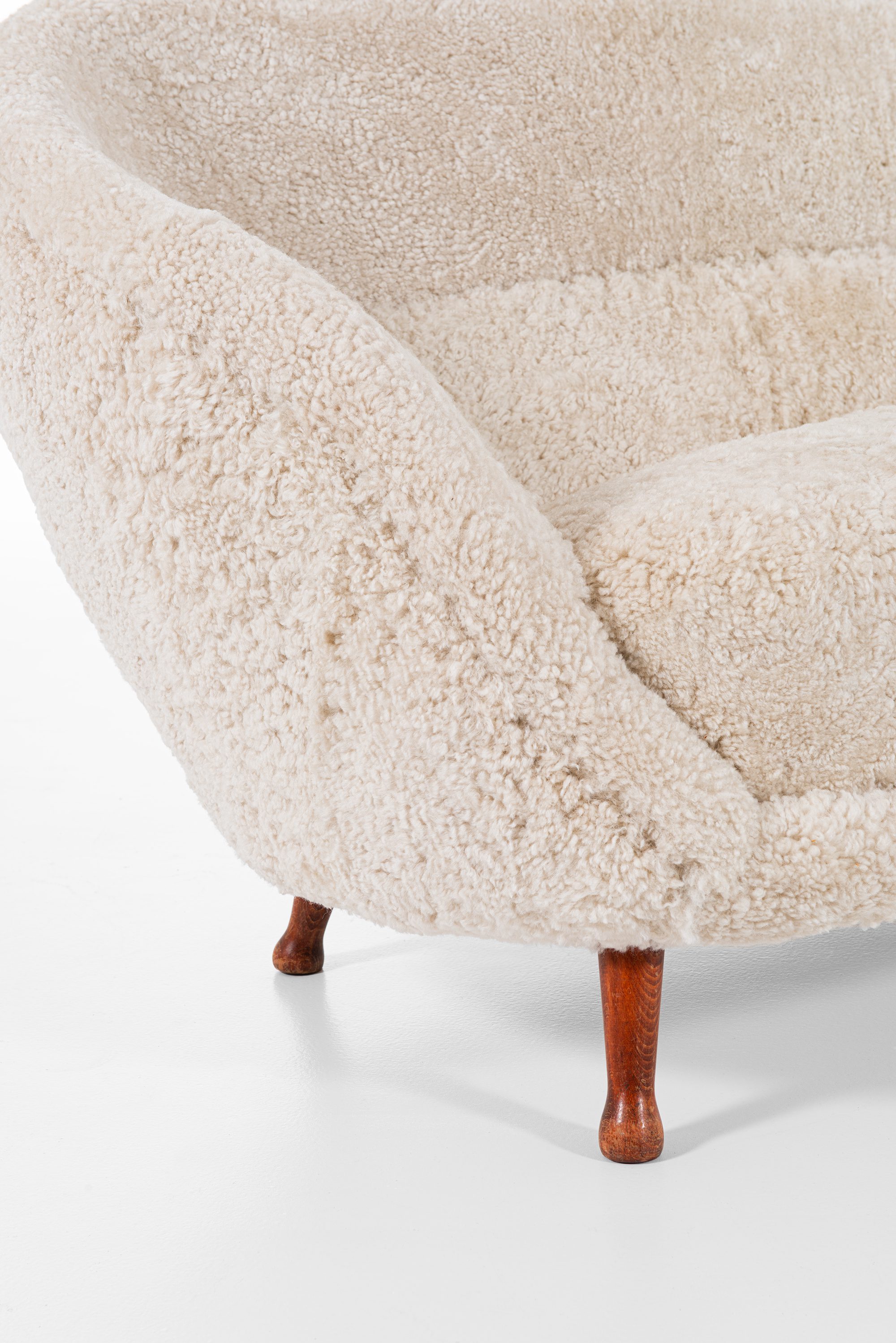Arne Norell sofa in dark stained beech and sheepskin at Studio Schalling