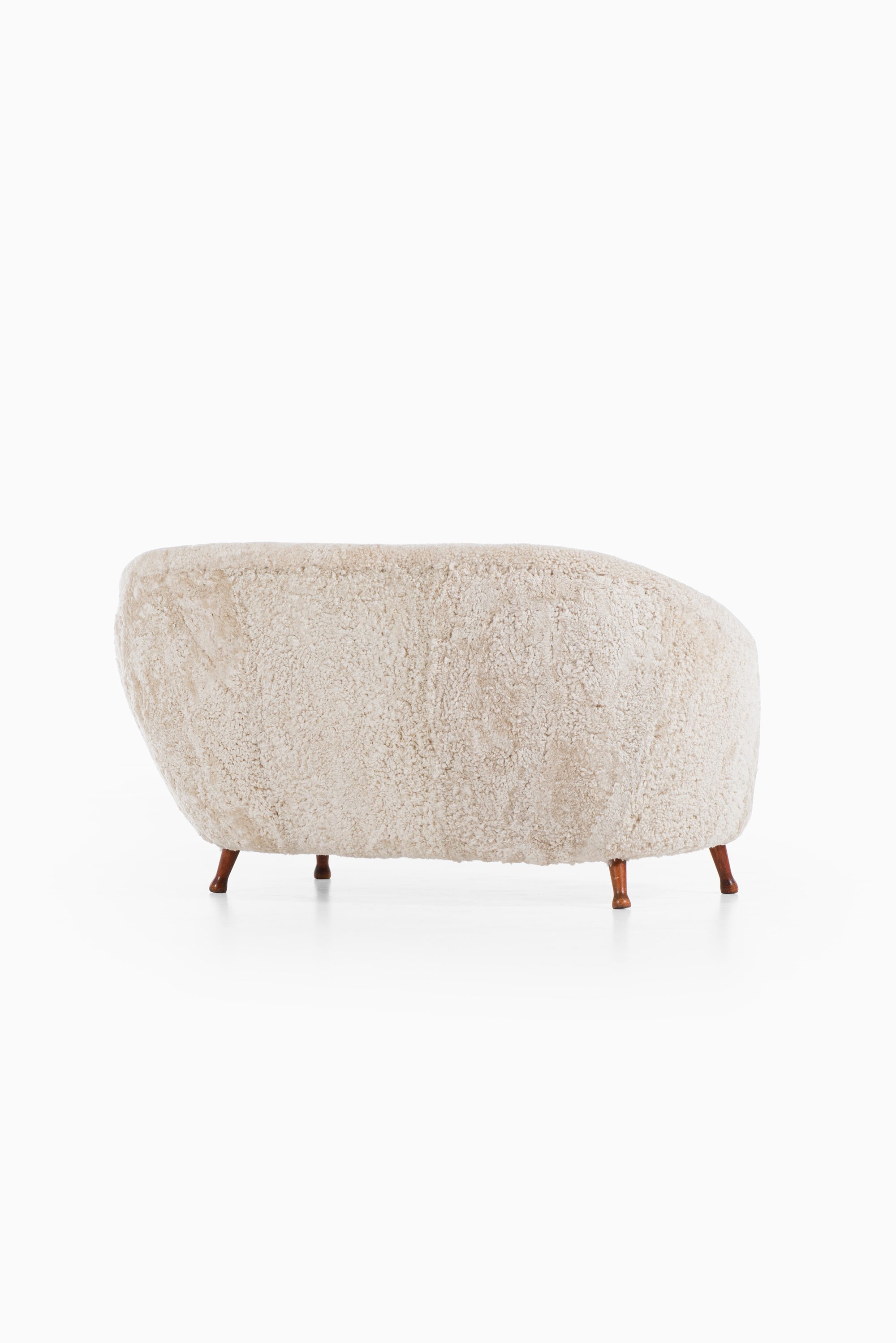 Arne Norell sofa in dark stained beech and sheepskin at Studio Schalling