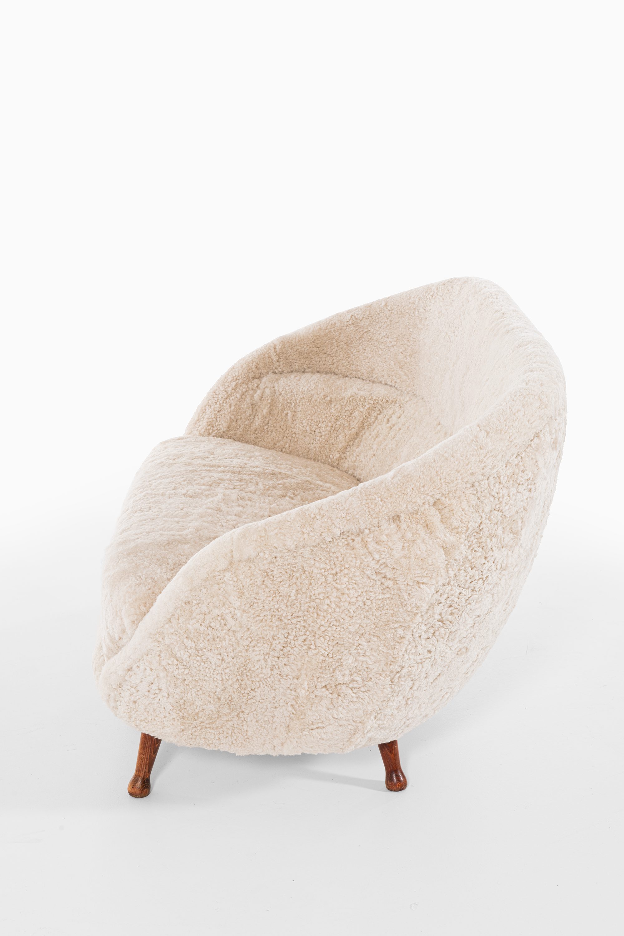 Arne Norell sofa in dark stained beech and sheepskin at Studio Schalling