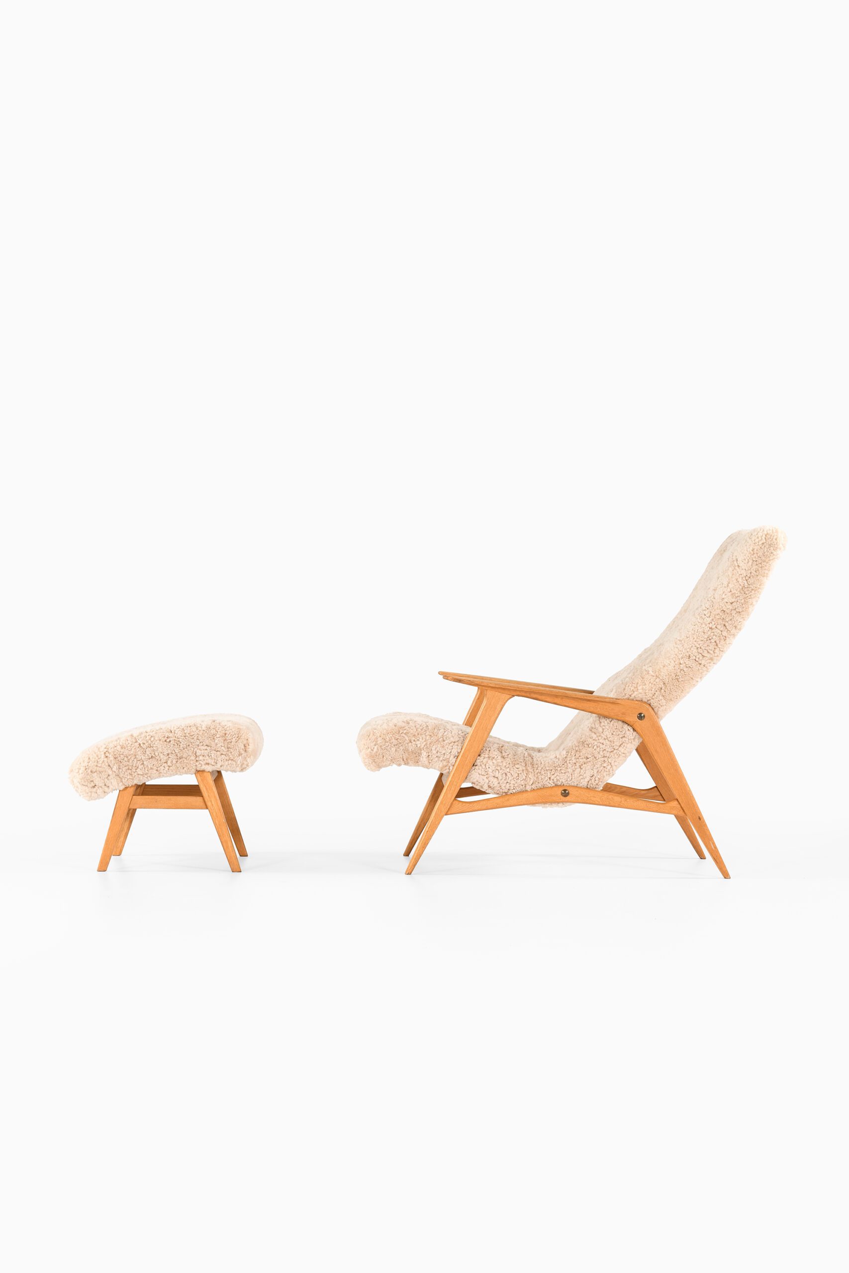 Easy chair with stool in sheepskin at Studio Schalling